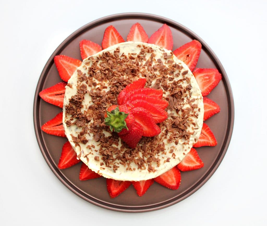 Ice cream cake decorated with chocolate and strawberries