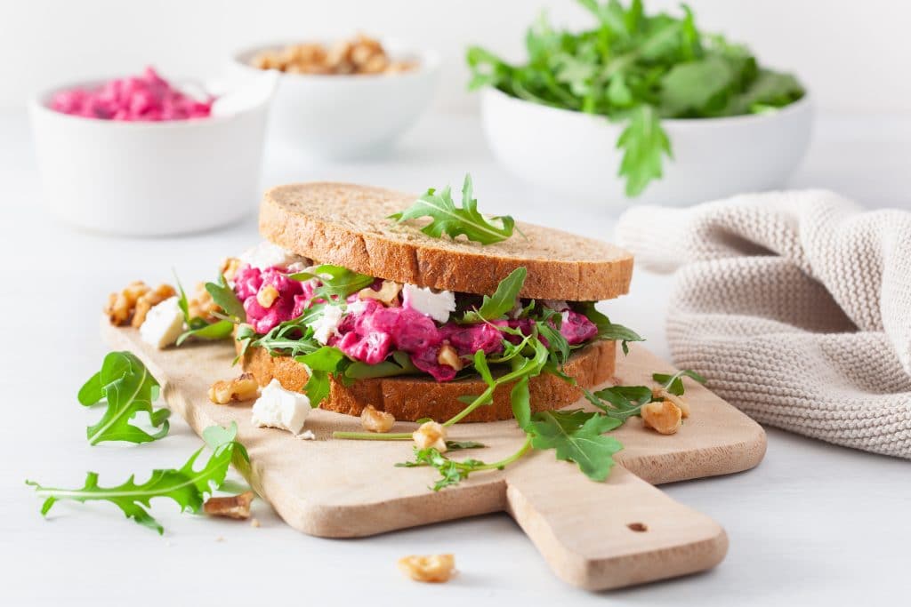 beetroot and feta cheese sandwich with walnuts and rocket