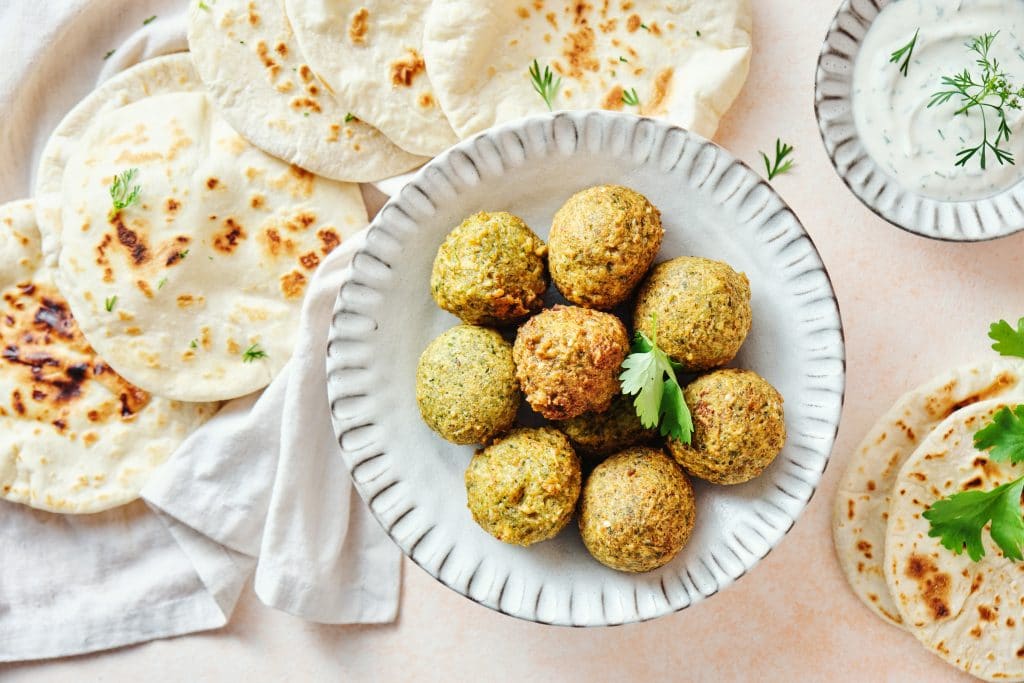 Homemade falafel and fresh pitas, Middle Eastern cuisine. Top view.