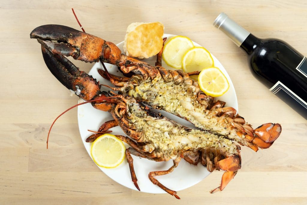 Oven baked marinated maine lobster with red wine bottle