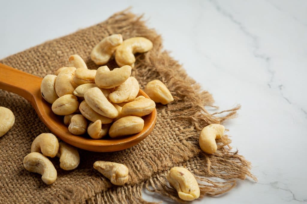 Raw cashews nuts on marble background