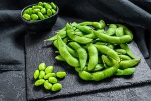 Green soy beans edamame. Black background. Top view.