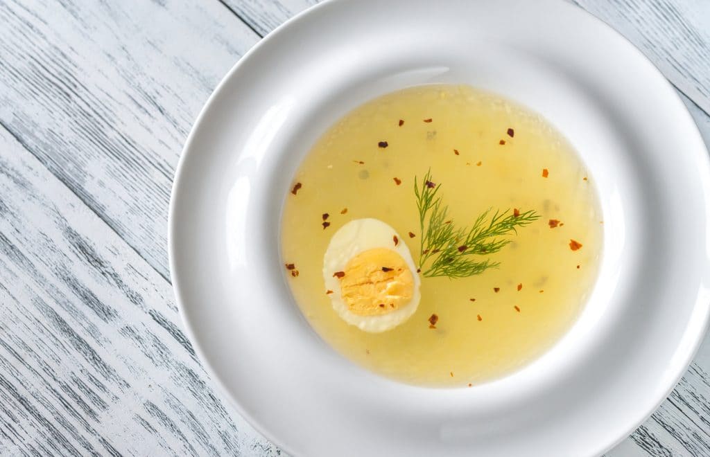 Portion of chicken stock on the wooden table