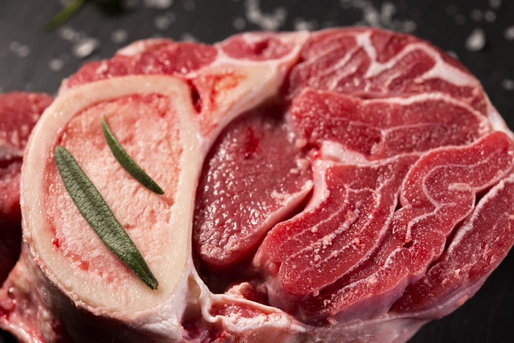 Piece of raw fresh beef shank, lower part of cow's foreleg with herbs