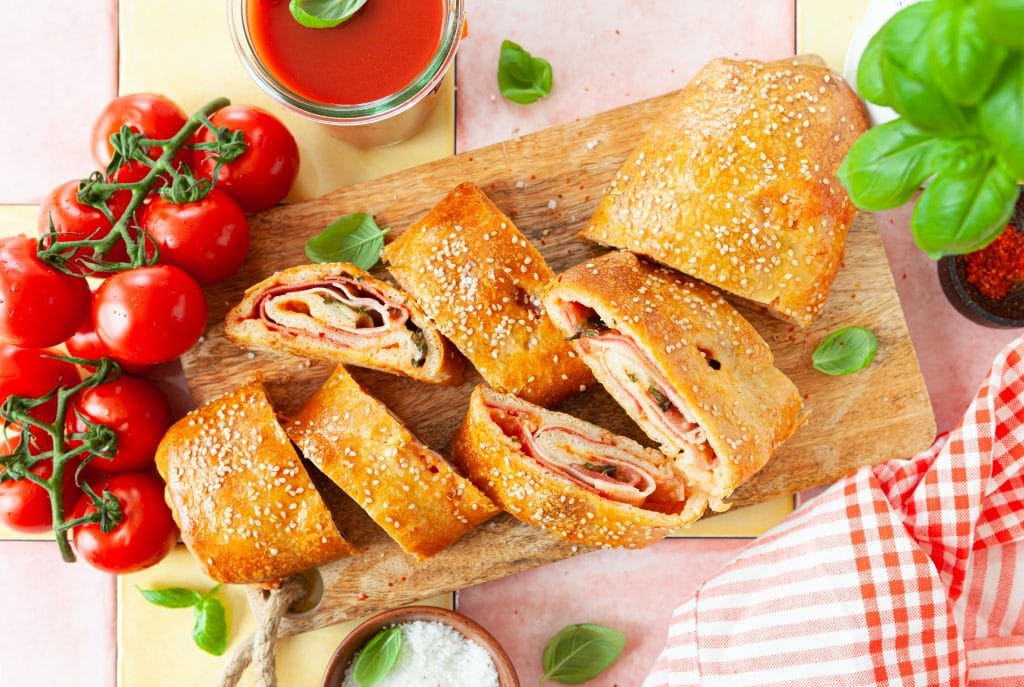 Italian stromboli, delicious pizza roll filled with sausage and ham