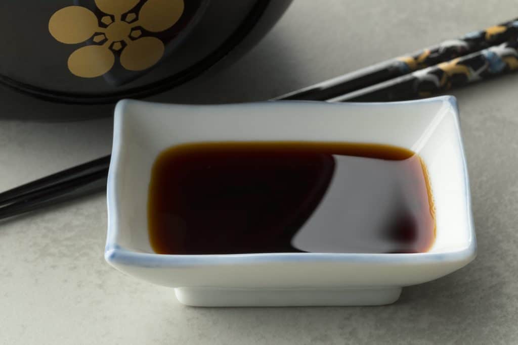 Traditional Japanese soy sauce in a bowl, ingredient for a meal