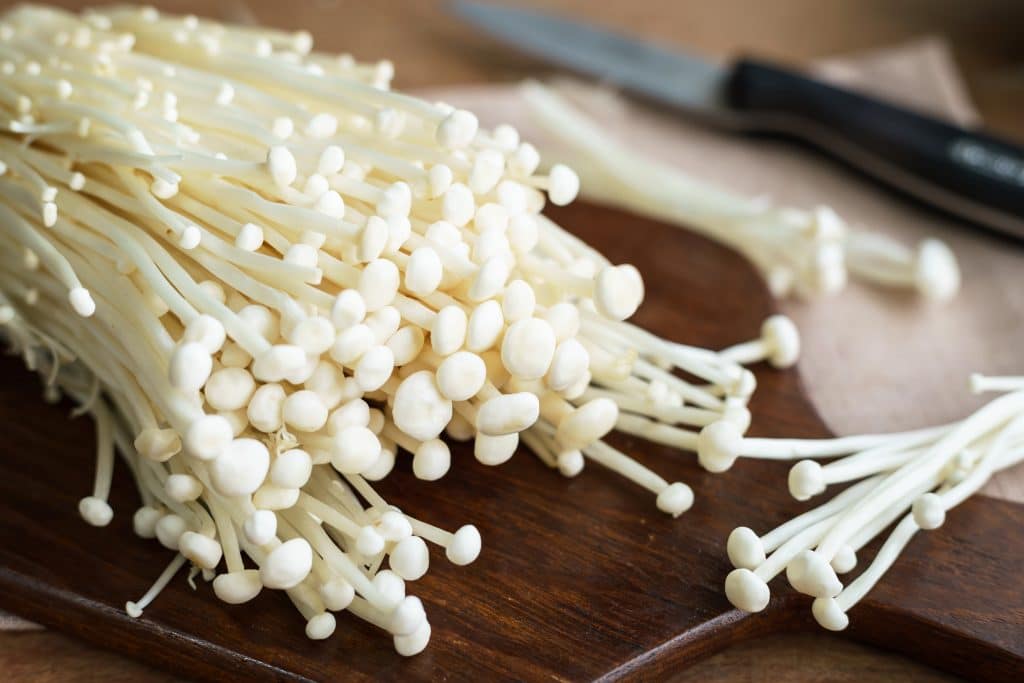 Enoki mushroom on wooden table for cooking