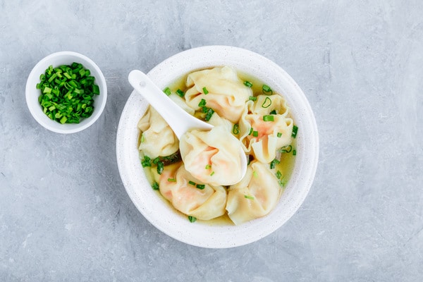 Wonton soup bowl. Shrimp or pork wonton soup with green onion, top view, copy space