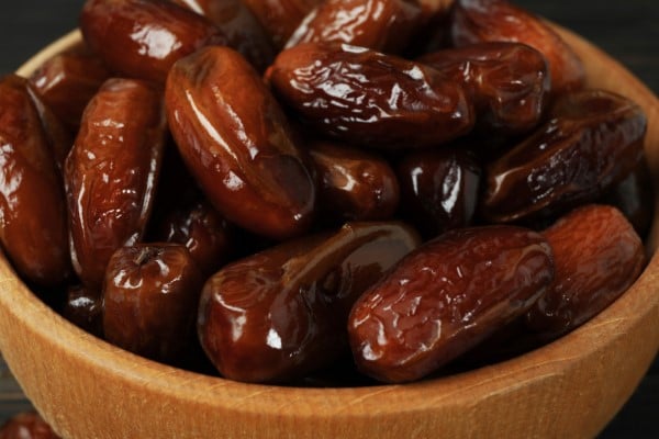 Bowl of tasty dates fruits, close up